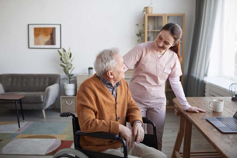 Older adult and family member touring a bright assisted living apartment with a staff guide